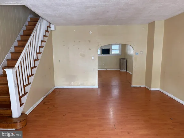 a view of a hallway with entryway wooden floor and front door