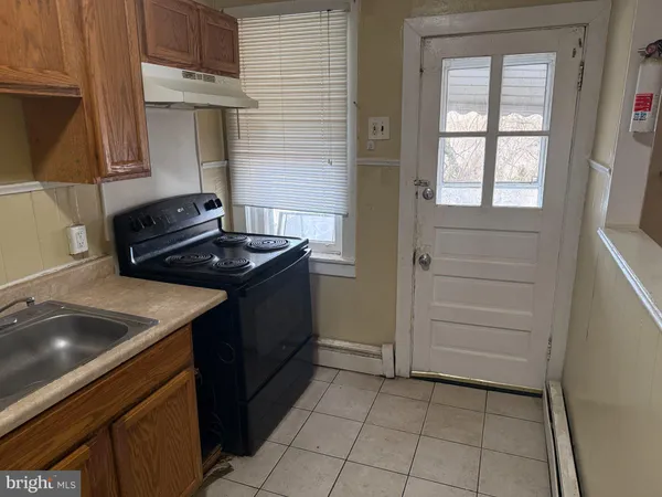 a kitchen that has a sink and a stove