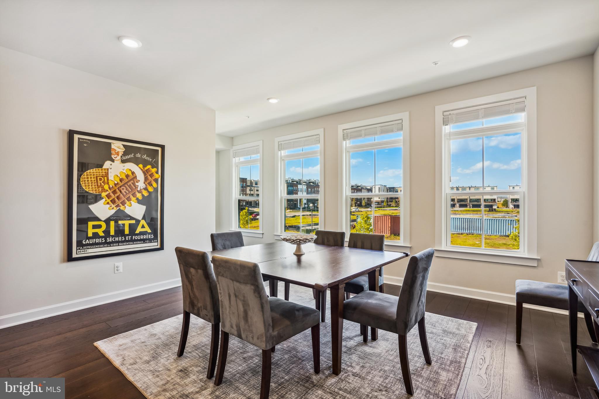 43469 Grandmoore Street Ashburn, VA 20148 - Photo 13 of 62 a view of a dining room with furniture a livingroom and wooden floor