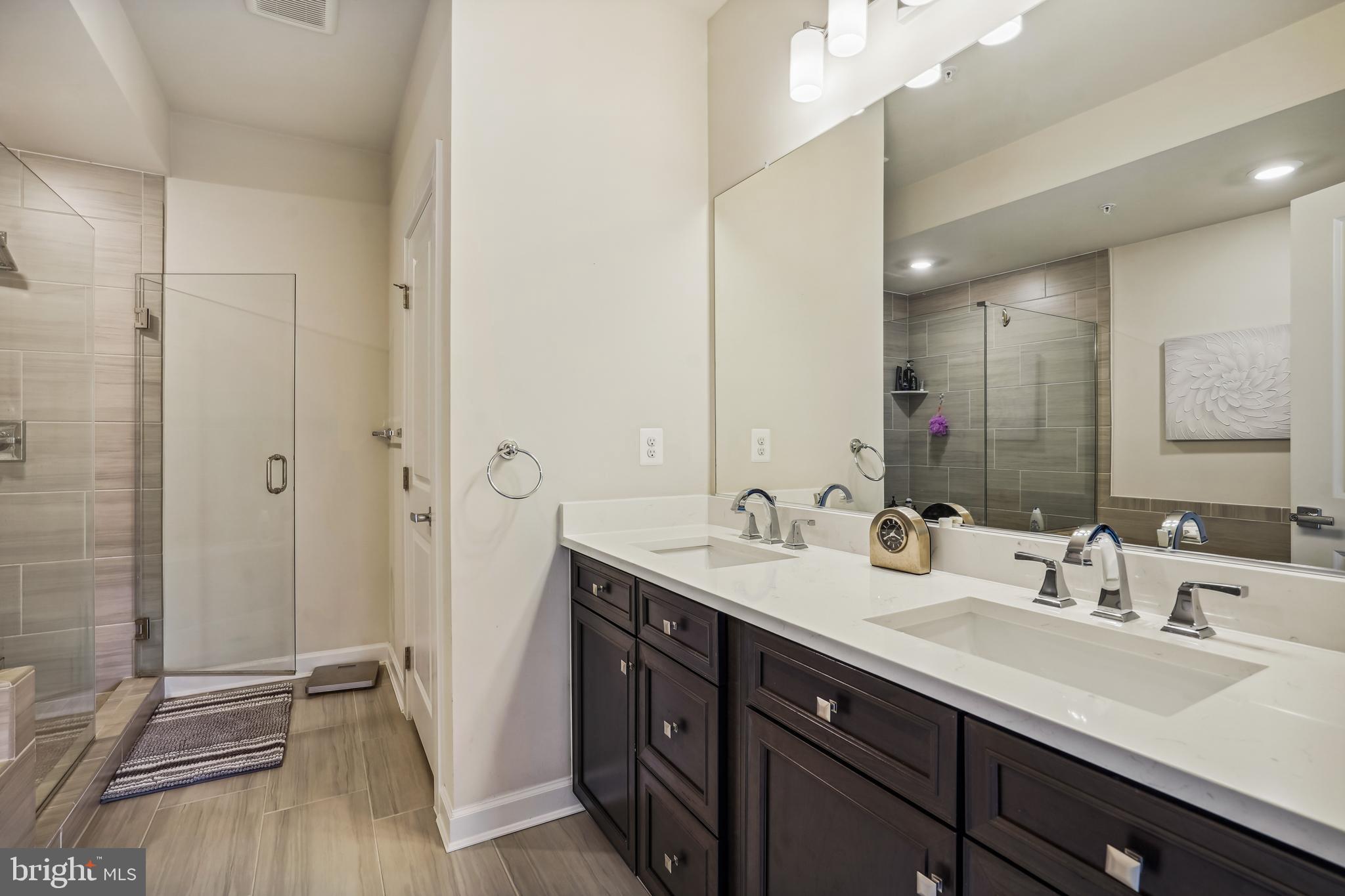 43469 Grandmoore Street Ashburn, VA 20148 - Photo 28 of 62 a bathroom with a double vanity sink and mirror