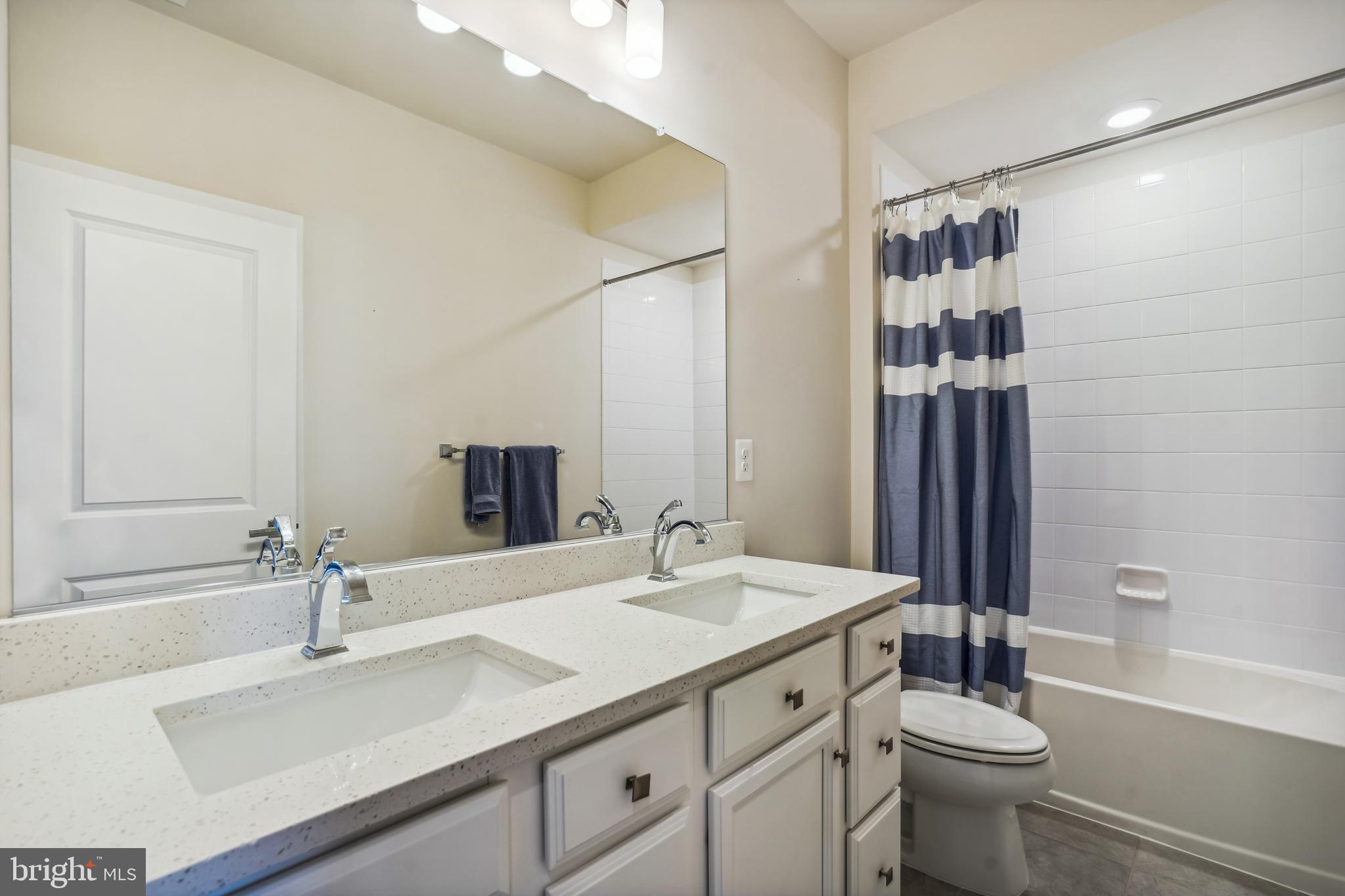 43469 Grandmoore Street Ashburn, VA 20148 - Photo 36 of 62 a bathroom with a sink and a mirror
