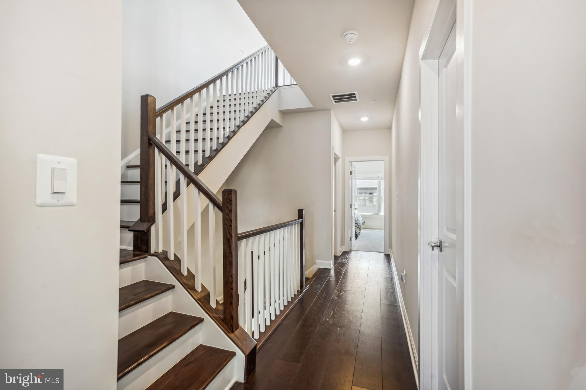 43469 Grandmoore Street Ashburn, VA 20148 - Photo 37 of 62 a view of a hallway with wooden floor and staircase