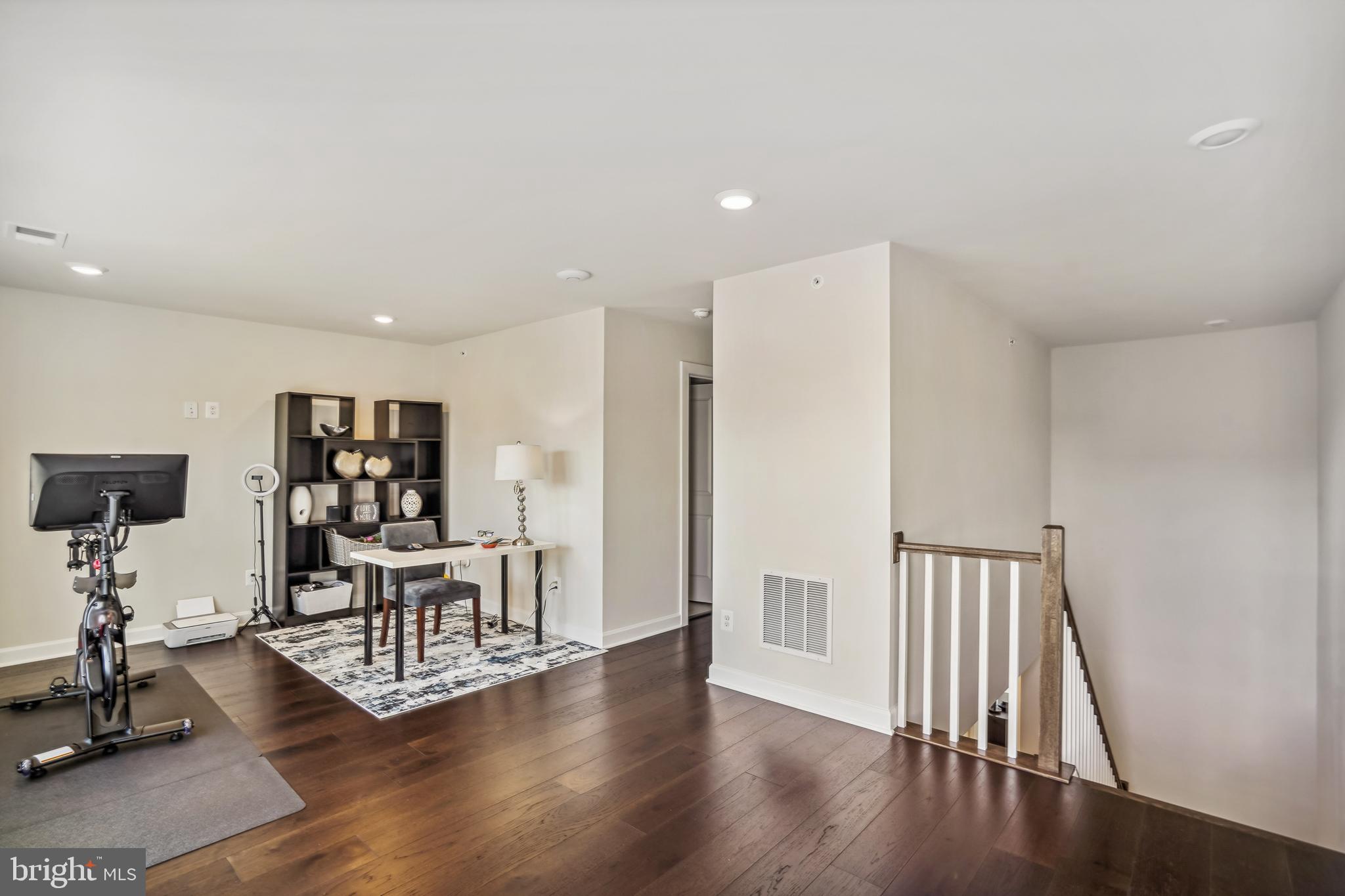 43469 Grandmoore Street Ashburn, VA 20148 - Photo 39 of 62 a view of a hallway with wooden floor and furniture