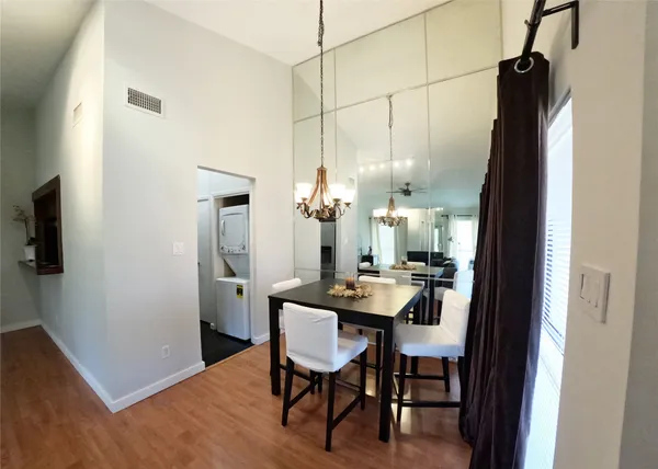 a view of a a dining room with furniture window and wooden floor