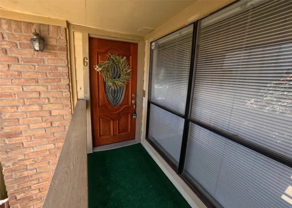 a walk in closet with wooden floor
