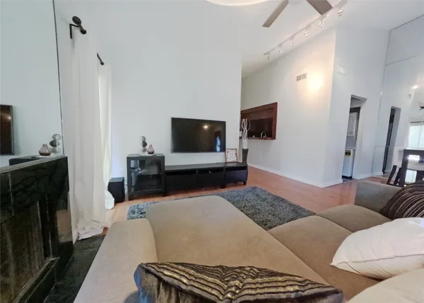 a living room with furniture and a wooden floor