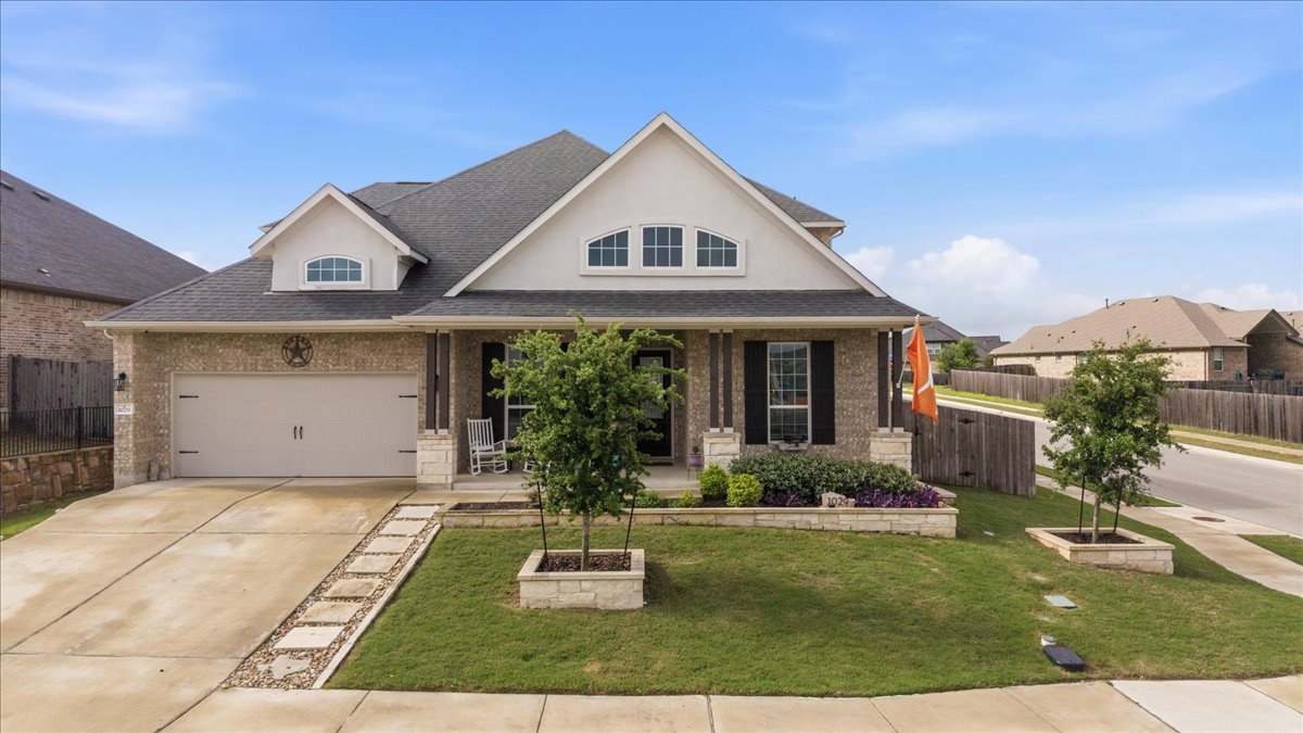 1029 Wild Pecan Loop Buda, TX 78610 - Photo 1 of 37 a front view of a house with a yard