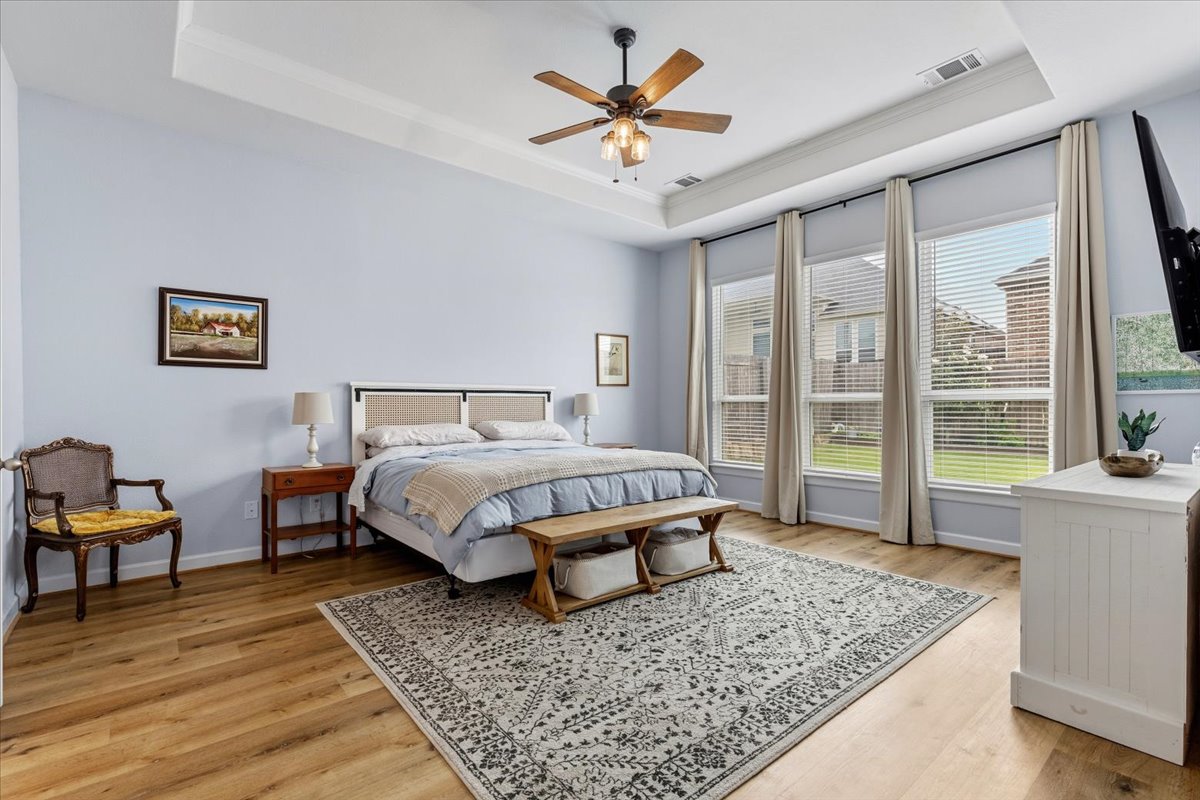 1029 Wild Pecan Loop Buda, TX 78610 - Photo 13 of 37 a bed sitting in a spacious bedroom next to a window