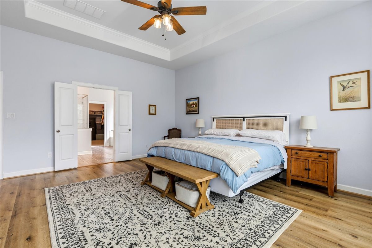 1029 Wild Pecan Loop Buda, TX 78610 - Photo 14 of 37 a bedroom with a bed rug and wooden floor