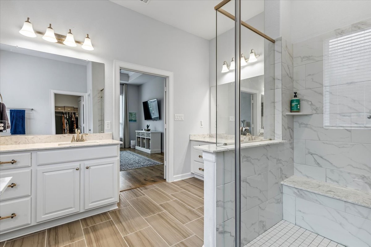 1029 Wild Pecan Loop Buda, TX 78610 - Photo 18 of 37 a spacious bathroom with a shower sink and mirror