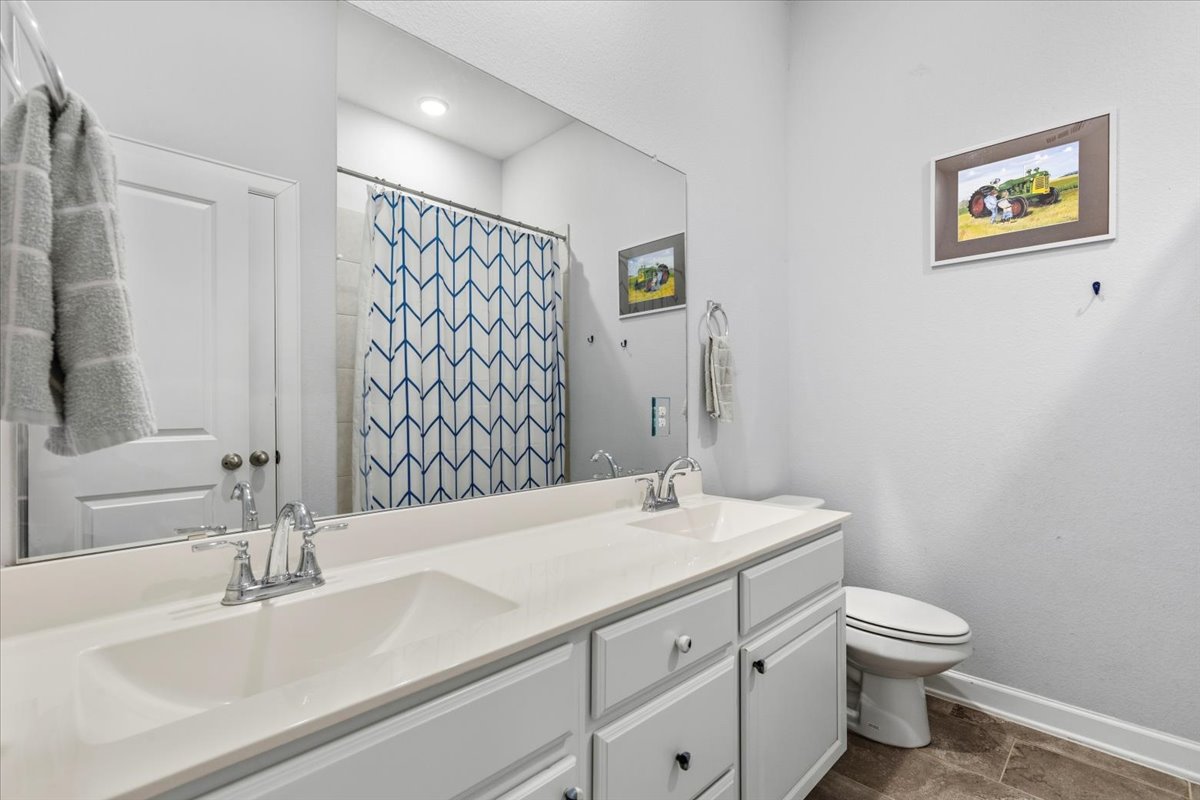1029 Wild Pecan Loop Buda, TX 78610 - Photo 19 of 37 a bathroom with a sink a toilet and shower