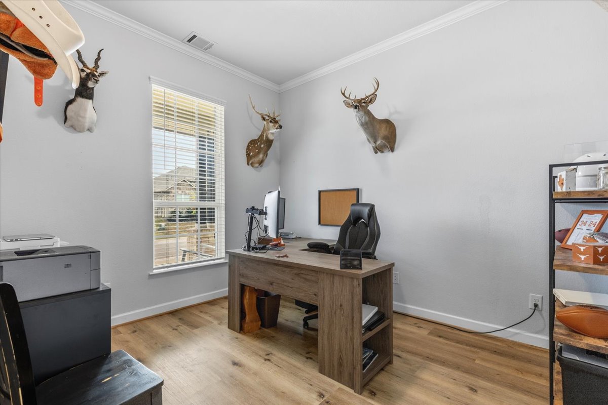 1029 Wild Pecan Loop Buda, TX 78610 - Photo 20 of 37 a view of a workspace with furniture and a window