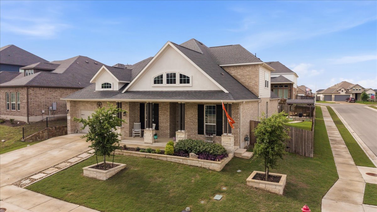 1029 Wild Pecan Loop Buda, TX 78610 - Photo 2 of 37 a front view of a house with garden