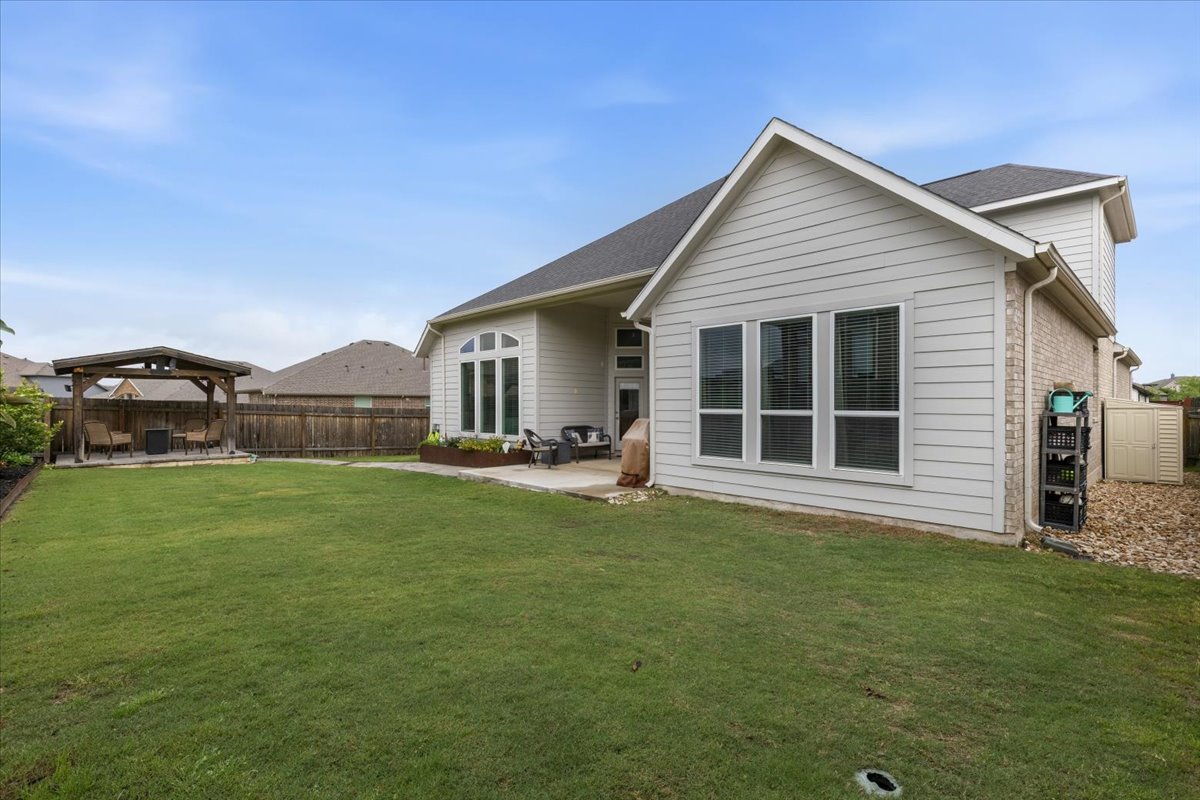 1029 Wild Pecan Loop Buda, TX 78610 - Photo 29 of 37 a view of a house with a backyard