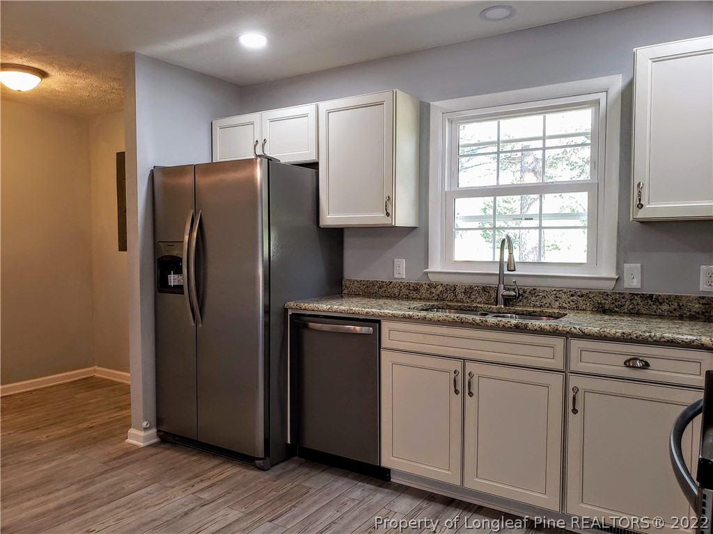 711 Reservation Road Aberdeen, NC 28315 - Photo 7 of 19 a kitchen with stainless steel appliances granite countertop a refrigerator sink and microwave