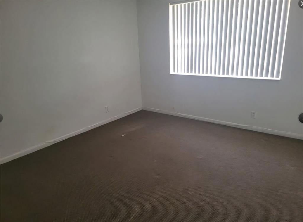 8741 Wiles Road, Unit 305 Coral Springs, FL 33067 - Photo 5 of 20 an empty room with a window