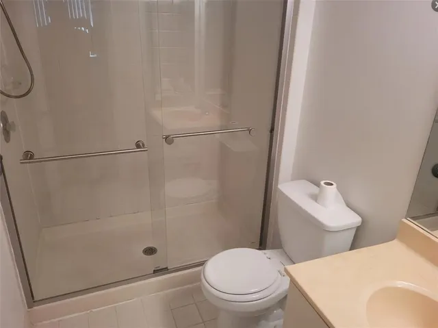 a white toilet sitting next to a bath tub