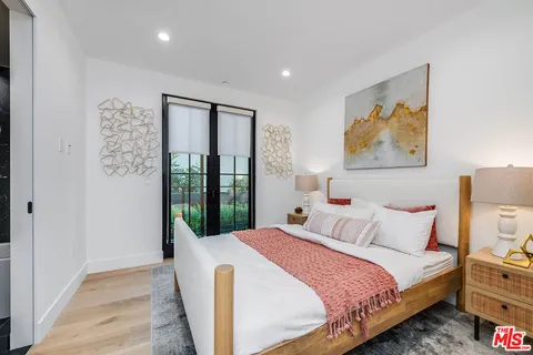 a bedroom with a bed and a painting on the wall