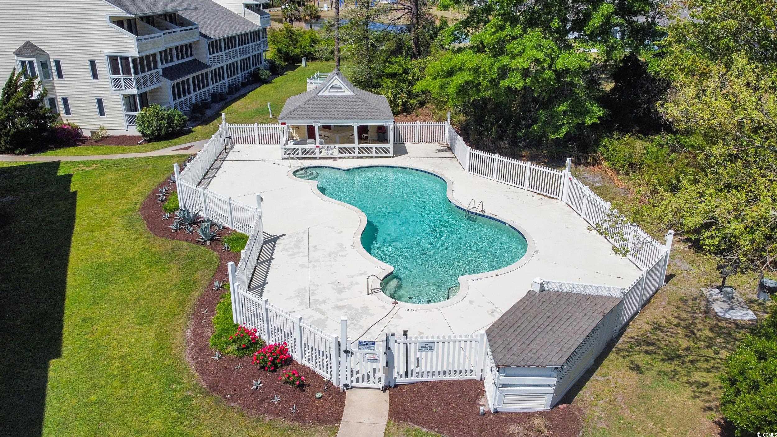 1100 Possum Trot Road, Unit G326 North Myrtle Beach, SC 29582 - Photo 16 of 21 Community pool featuring an outdoor structure, a patio, a fenced backyard, an exterior structure, and a wooden deck