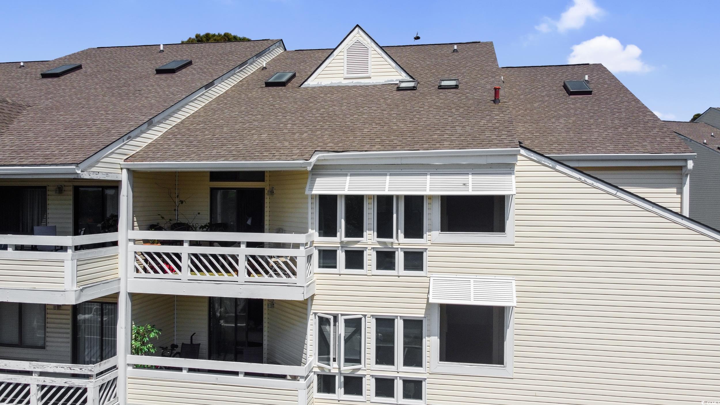 1100 Possum Trot Road, Unit G326 North Myrtle Beach, SC 29582 - Photo 19 of 21 Rear view of property featuring a shingled roof and a balcony
