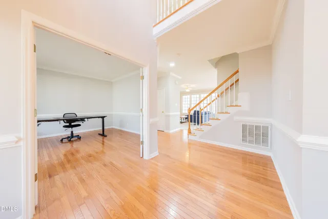 a view of a room with wooden floor and stairs