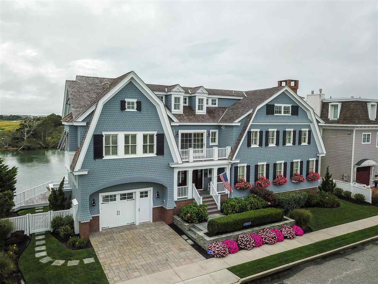 498 7th Street Avalon, NJ 08202 - Photo 1 of 36 a front view of a house with a garden