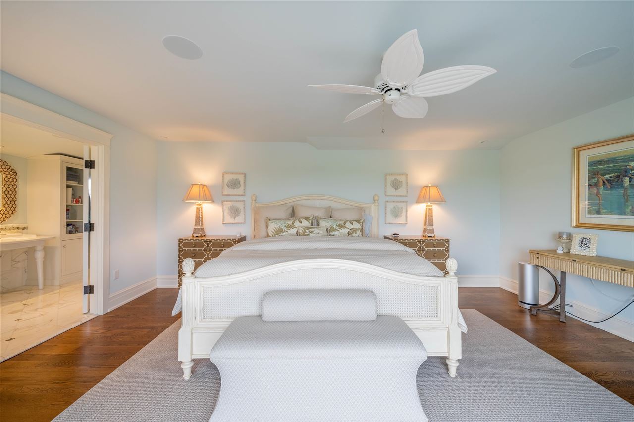 498 7th Street Avalon, NJ 08202 - Photo 22 of 36 a bedroom with a bed and a chandelier