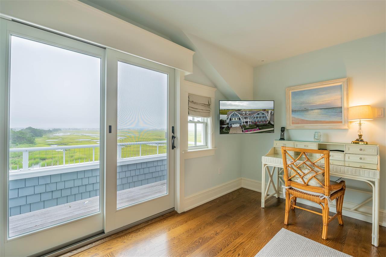 498 7th Street Avalon, NJ 08202 - Photo 23 of 36 a dining room with furniture and a floor to ceiling window