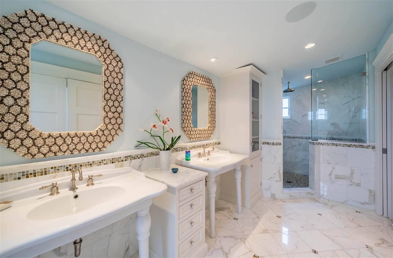 498 7th Street Avalon, NJ 08202 - Photo 24 of 36 a bathroom with a double vanity sink mirror and shower