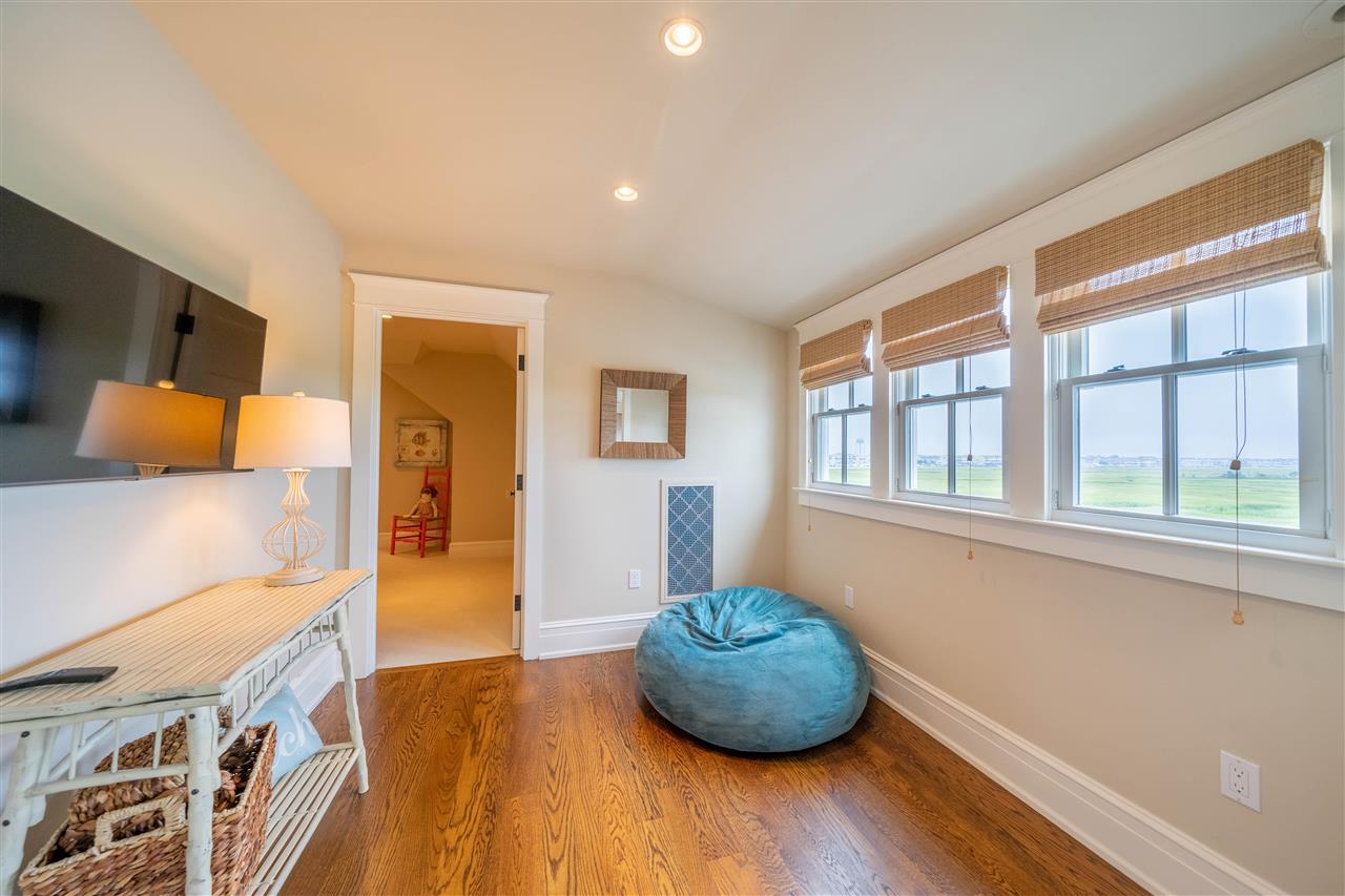 498 7th Street Avalon, NJ 08202 - Photo 26 of 36 a living room with furniture and a table