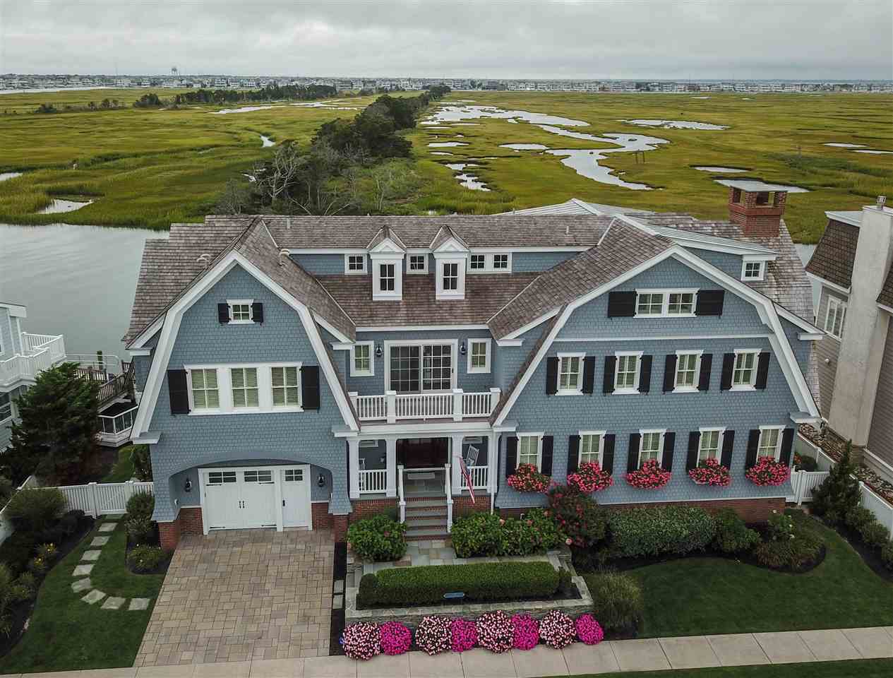 498 7th Street Avalon, NJ 08202 - Photo 31 of 36 a front view of a house with a garden and lake view
