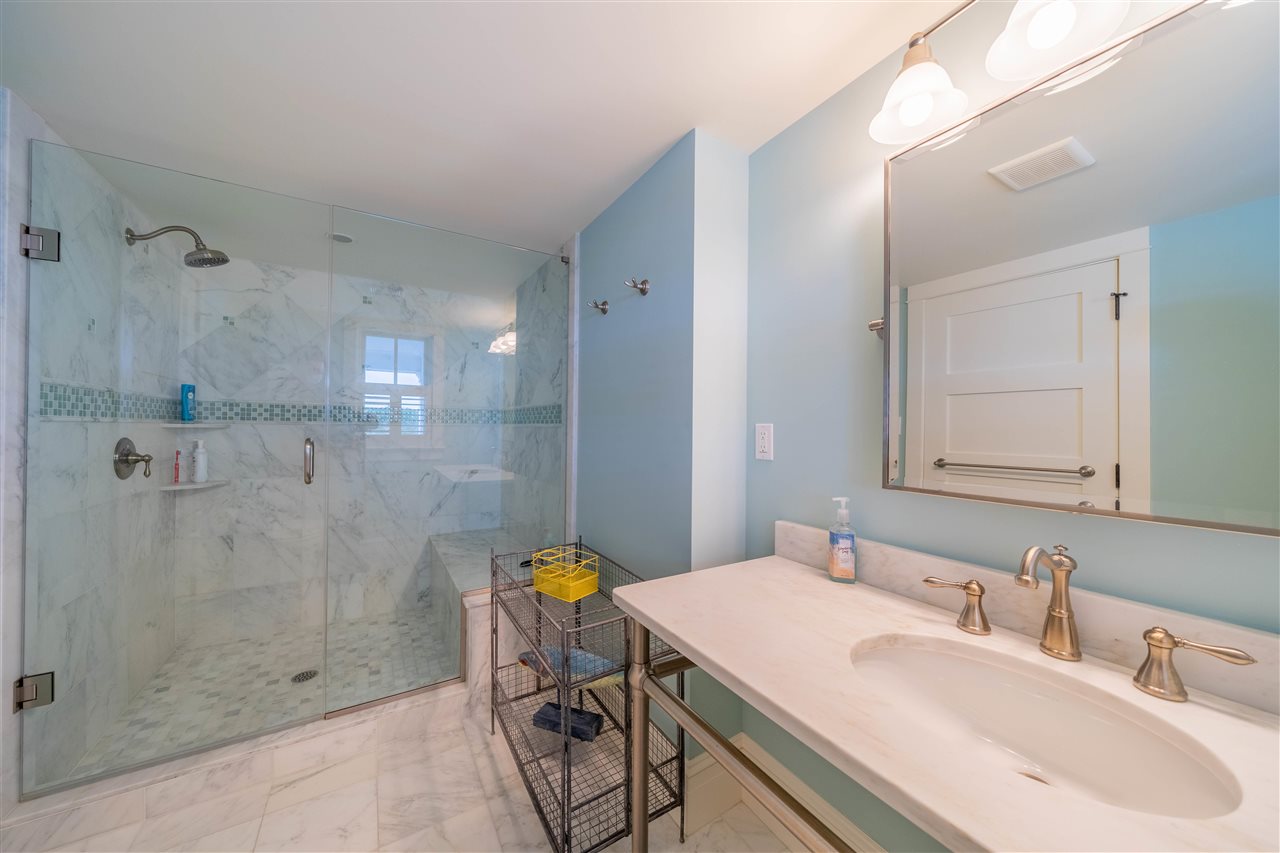 498 7th Street Avalon, NJ 08202 - Photo 7 of 36 a bathroom with a sink shower and a mirror