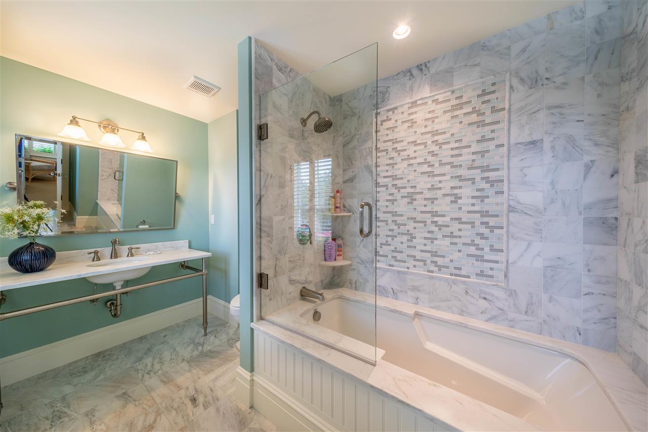 498 7th Street Avalon, NJ 08202 - Photo 9 of 36 a bathroom with a bathtub sink and mirror
