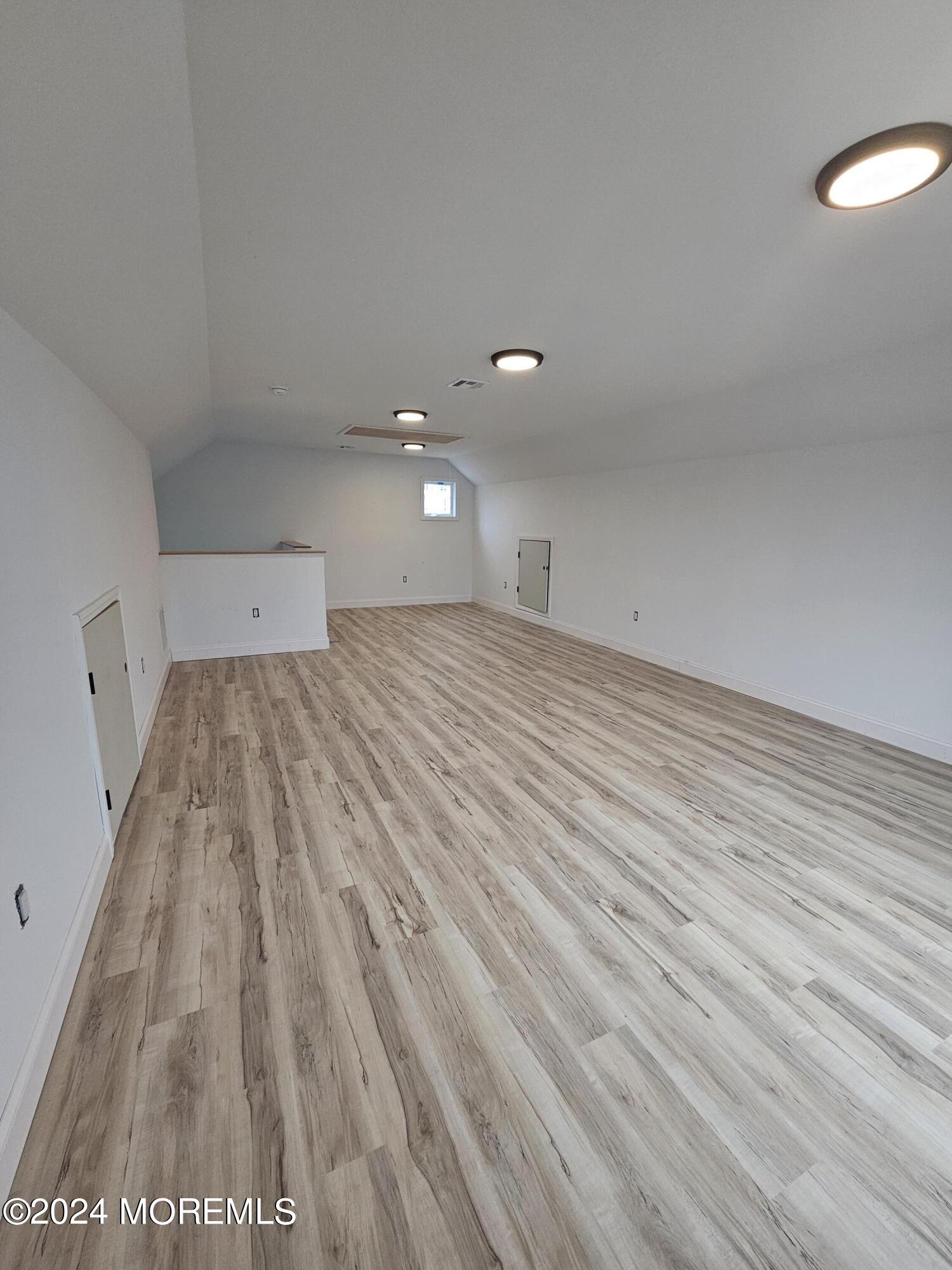91 Illinois Avenue Waretown, NJ 08758 - Photo 11 of 12 a view of a room with wooden floor and white walls
