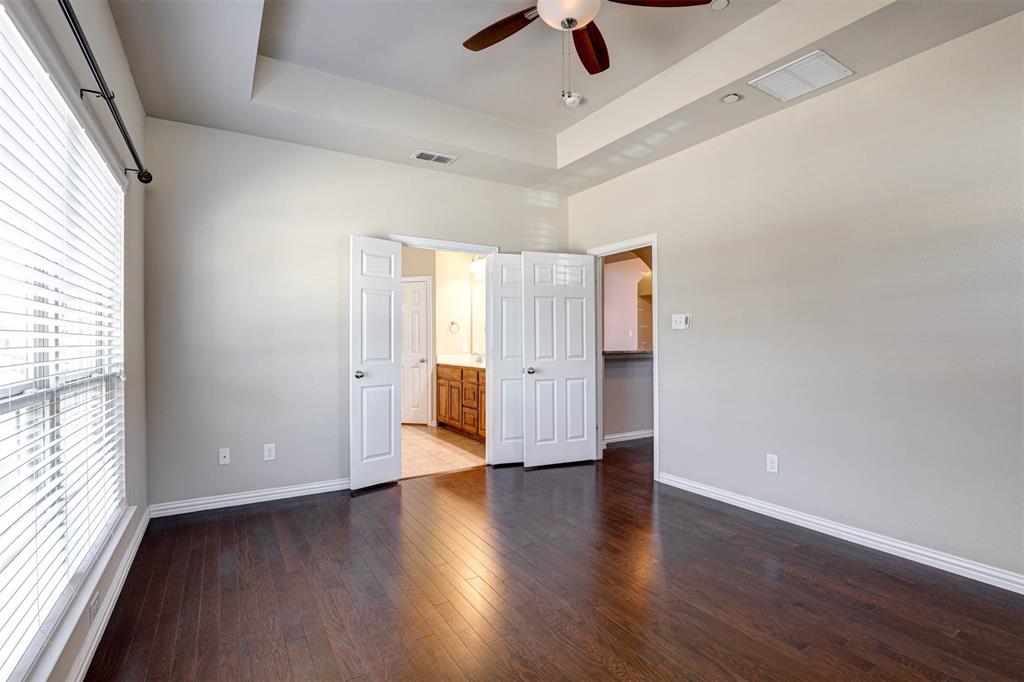 5633 Hummingbird Lane Fairview, TX 75069 - Photo 15 of 25 an empty room with wooden floor and windows