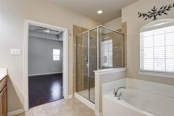 a bathroom with a bathtub and a shower