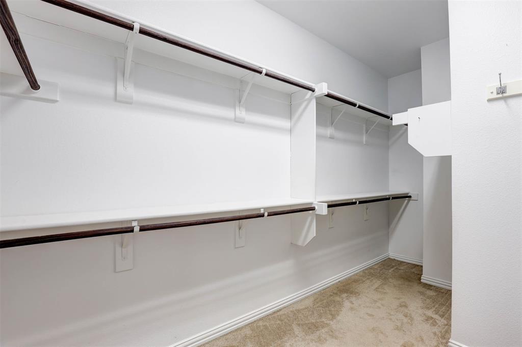5633 Hummingbird Lane Fairview, TX 75069 - Photo 19 of 25 a view of walk in closet with empty racks