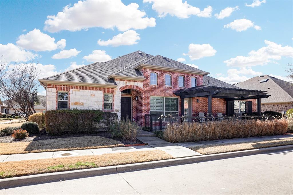 5633 Hummingbird Lane Fairview, TX 75069 - Photo 2 of 25 a front view of a house with a yard and garage