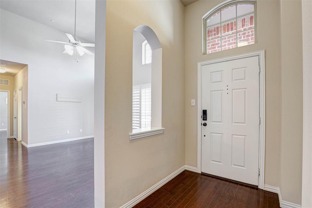 5633 Hummingbird Lane Fairview, TX 75069 - Photo 3 of 25 an empty room with windows and wooden floor