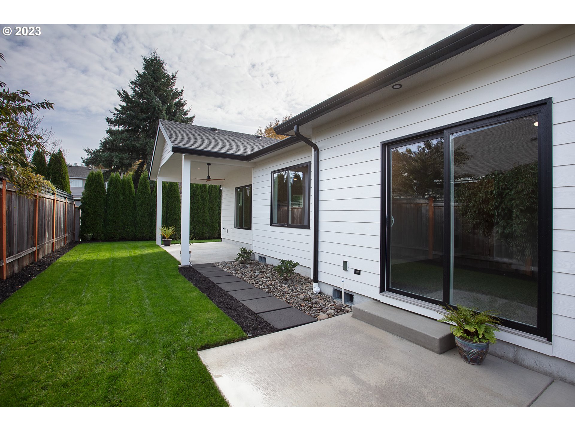 806 Salmonberry Street Springfield, OR 97477 - Photo 27 of 31 a backyard of a house with table and chairs with wooden fence