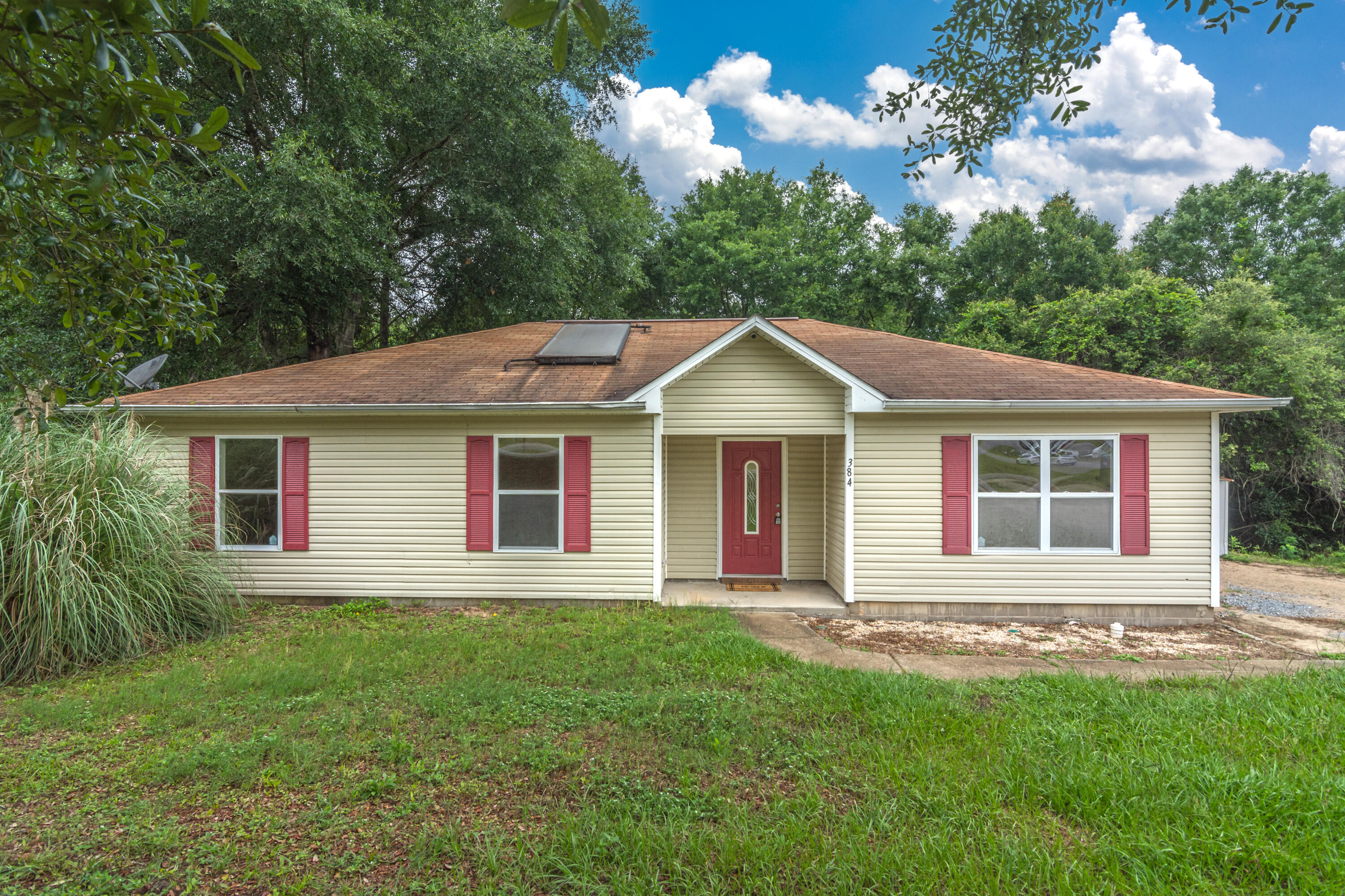 a front view of a house with a garden