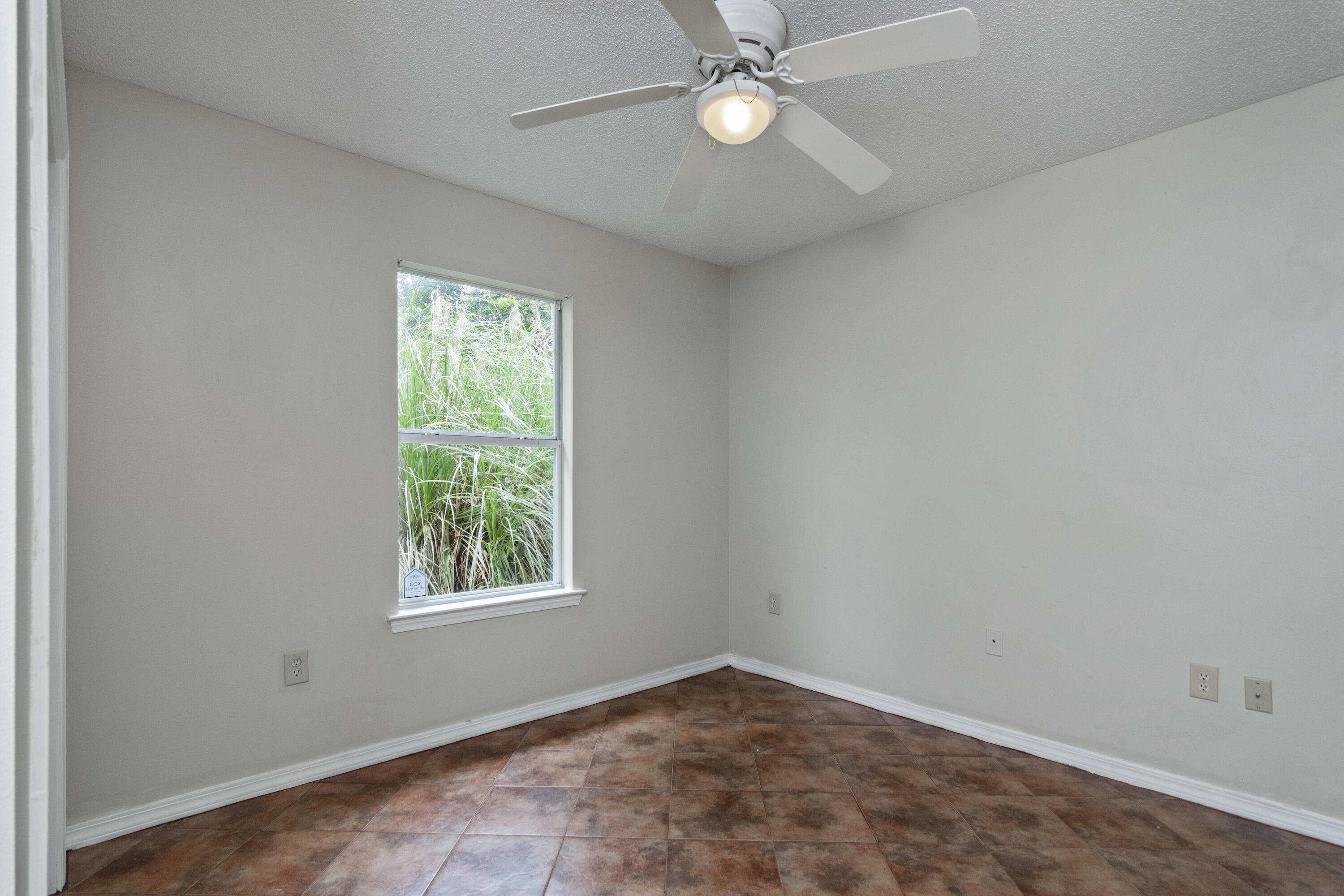 384 John King Road Crestview, FL 32539 - Photo 13 of 21 an empty room with a window and a fan