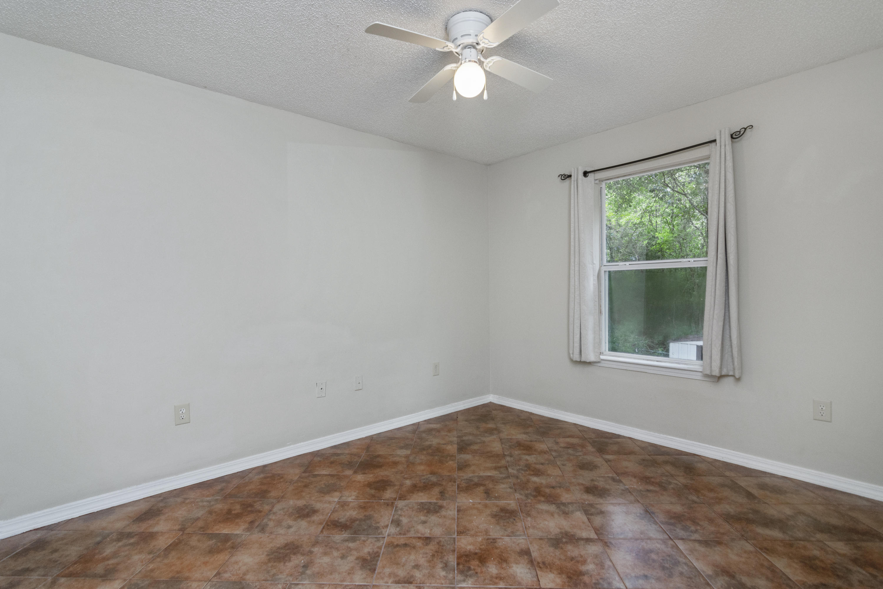 384 John King Road Crestview, FL 32539 - Photo 15 of 21 an empty room with a window and ceiling fan