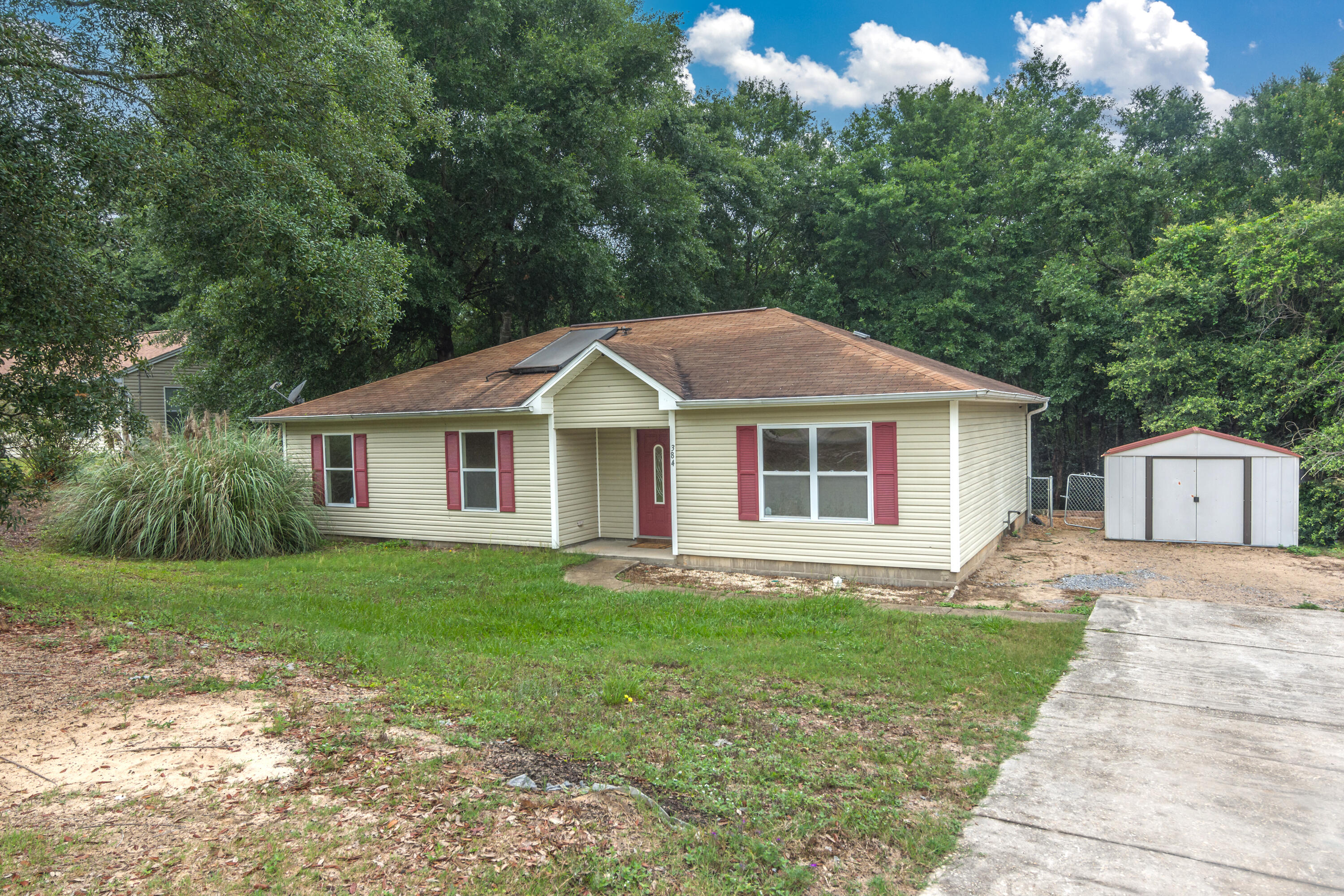384 John King Road Crestview, FL 32539 - Photo 20 of 21 a front view of a house with a garden