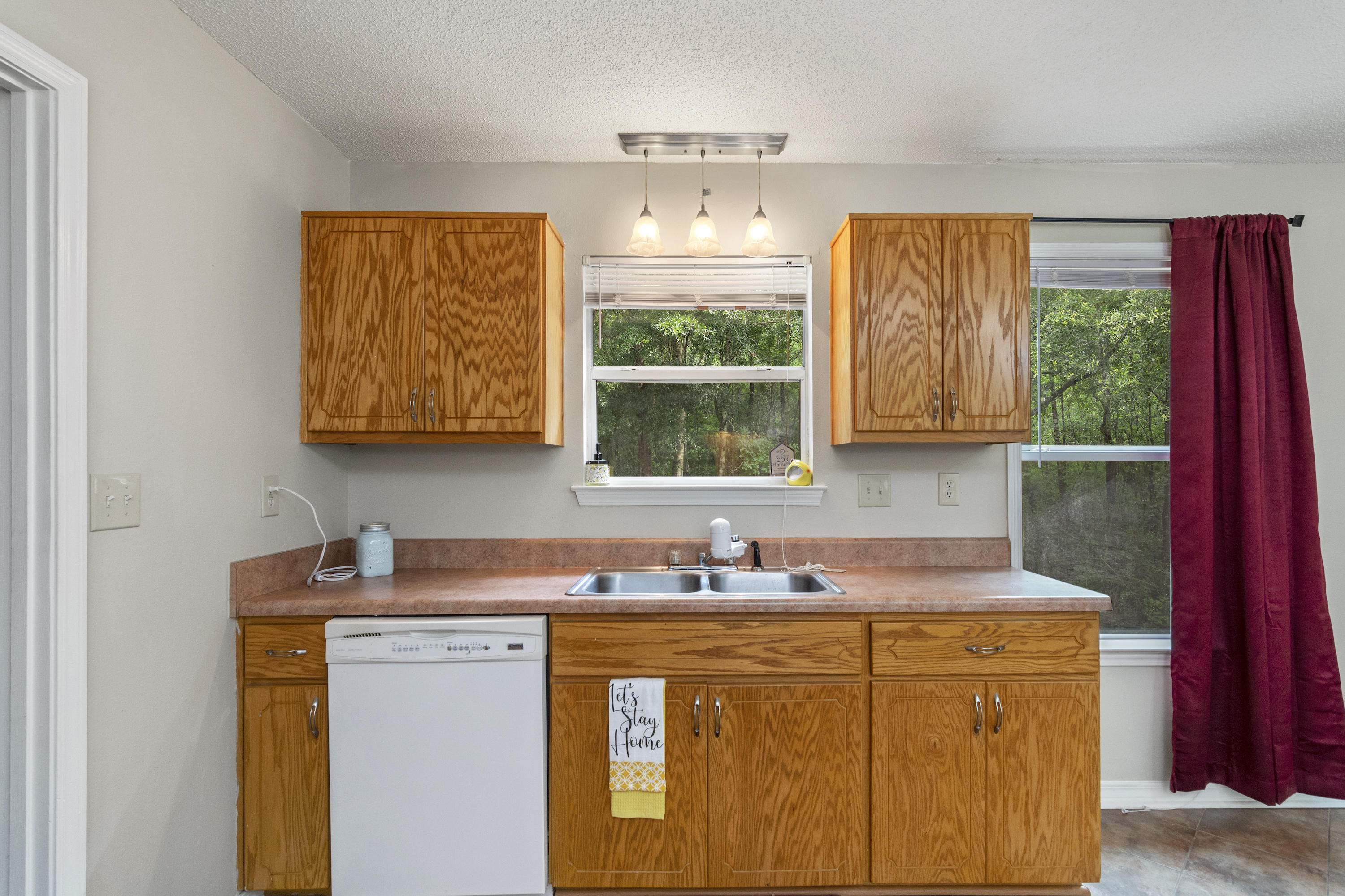 384 John King Road Crestview, FL 32539 - Photo 5 of 21 a kitchen with stainless steel appliances granite countertop a sink a stove and a wooden cabinets