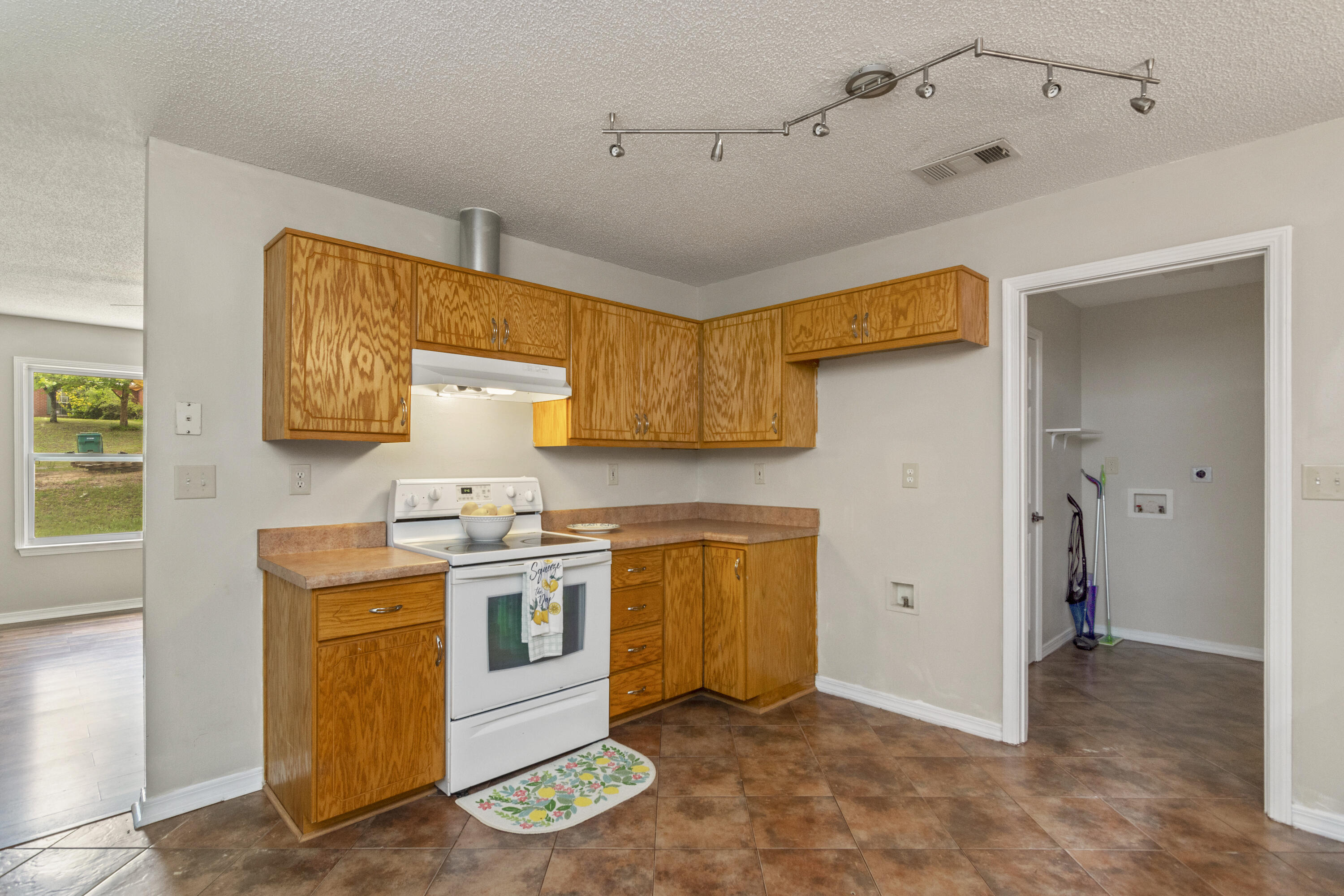384 John King Road Crestview, FL 32539 - Photo 6 of 21 a kitchen with stainless steel appliances granite countertop a stove a sink and a refrigerator