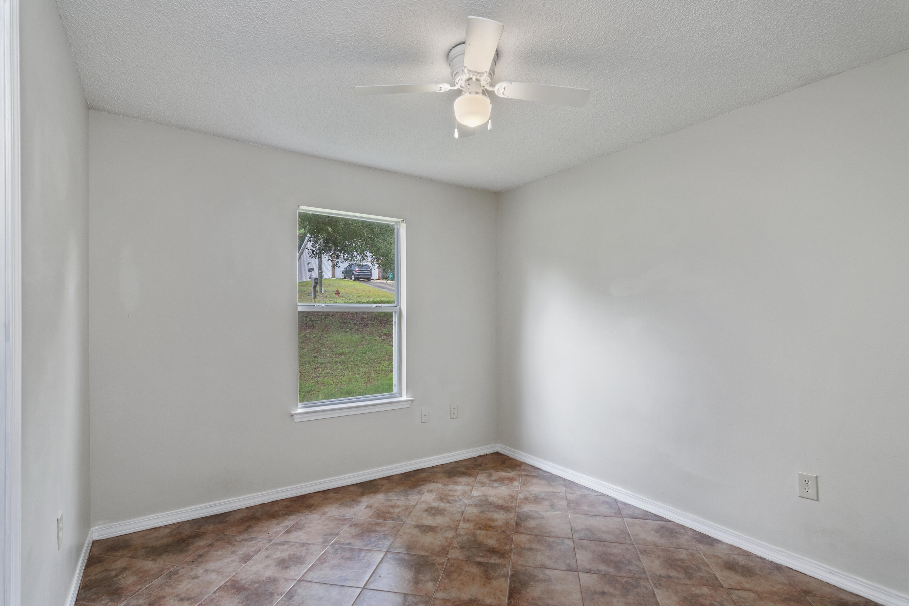 384 John King Road Crestview, FL 32539 - Photo 8 of 21 an empty room with windows and fan