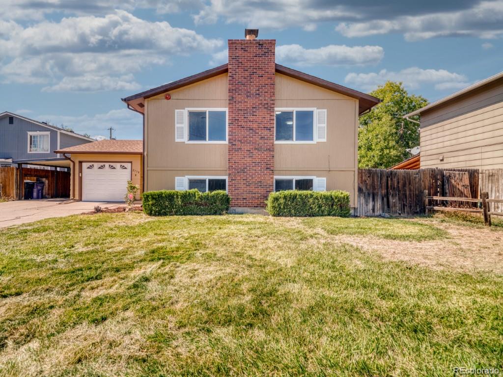 2730 West Mississippi Avenue, Unit 8 Denver, CO 80219 - Photo 1 of 40 a front view of a house with a yard