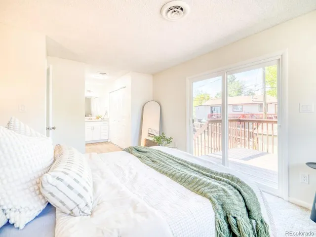 a bedroom with a bed and a large window