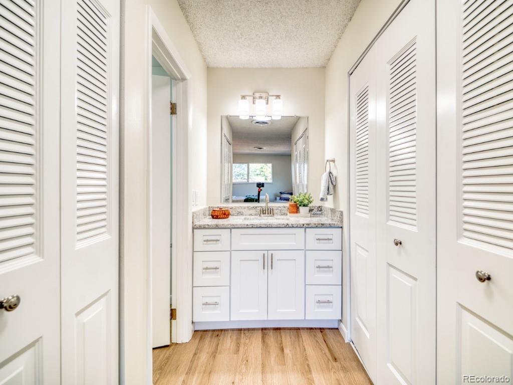 2730 West Mississippi Avenue, Unit 8 Denver, CO 80219 - Photo 14 of 40 a bathroom with a vanity and a mirror